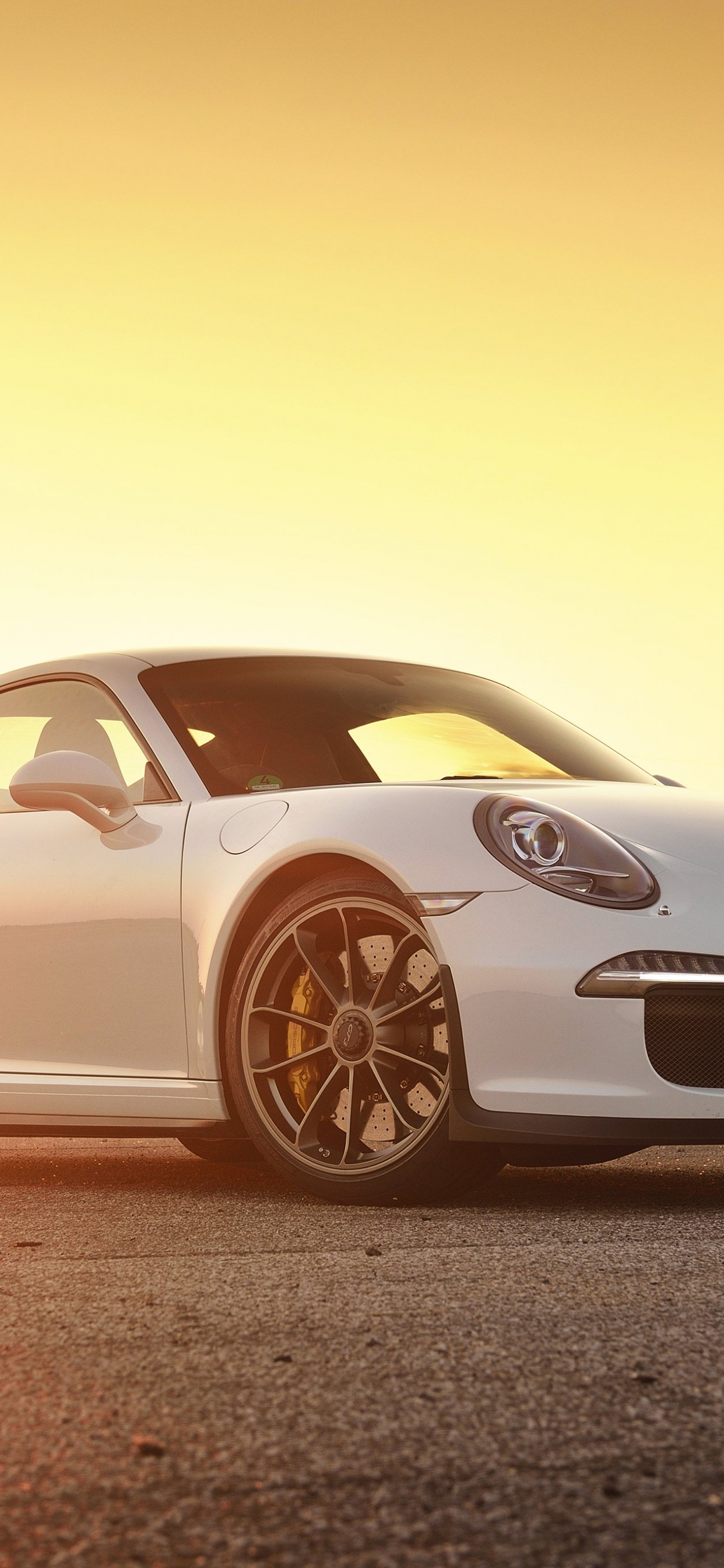 White Porsche 911 on Brown Field. Wallpaper in 1242x2688 Resolution