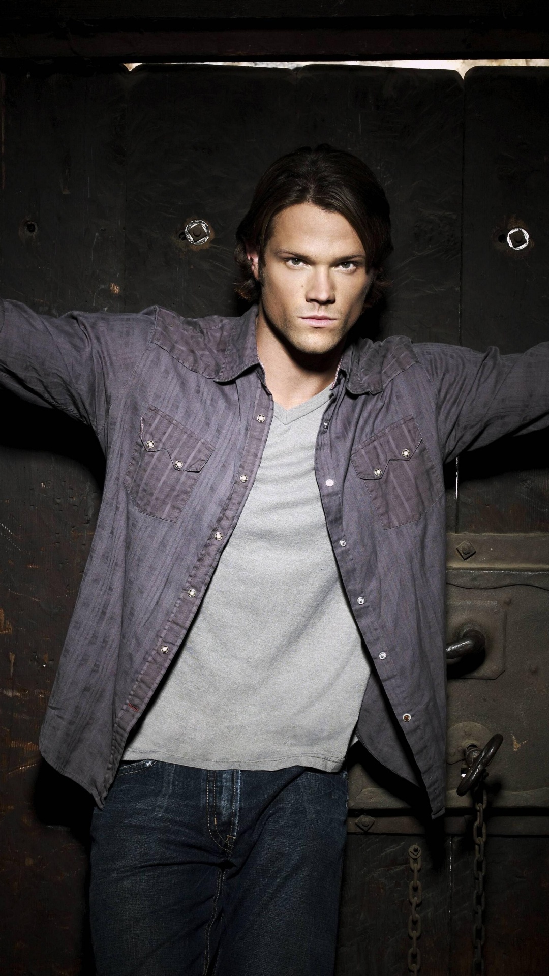 Woman in Blue Denim Jacket Standing Beside Brown Wooden Door. Wallpaper in 1080x1920 Resolution