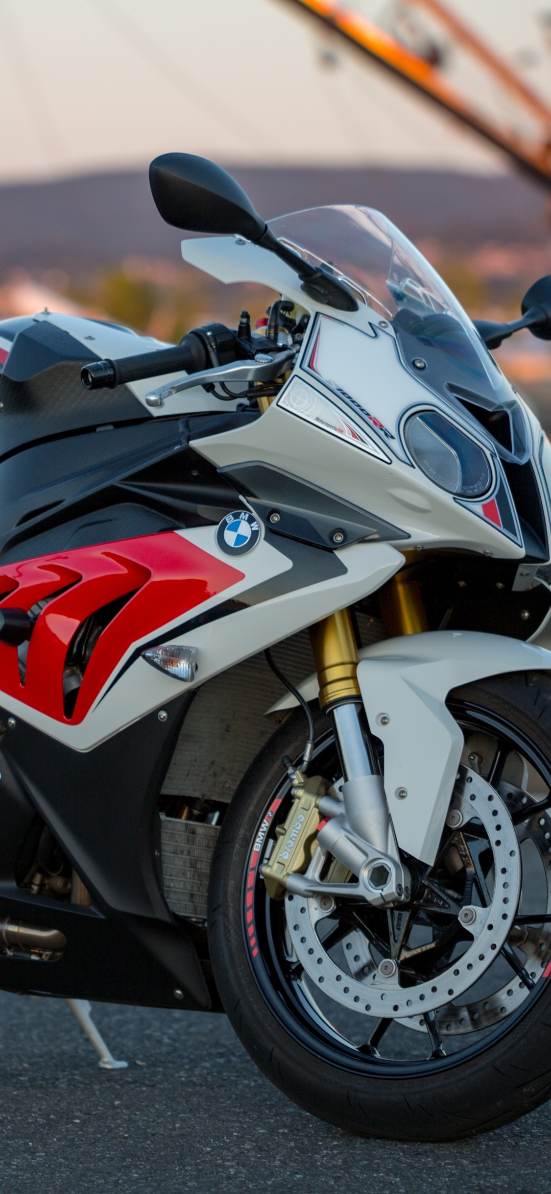 Red and Black Sports Bike on Road During Daytime. Wallpaper in 1125x2436 Resolution