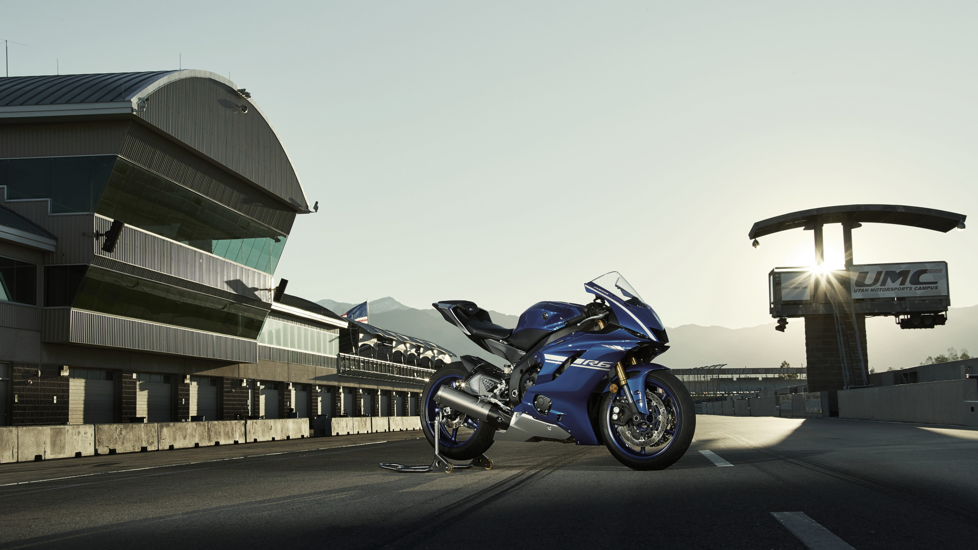 Blue and Black Sports Bike Parked on Gray Concrete Road During Daytime. Wallpaper in 1920x1080 Resolution