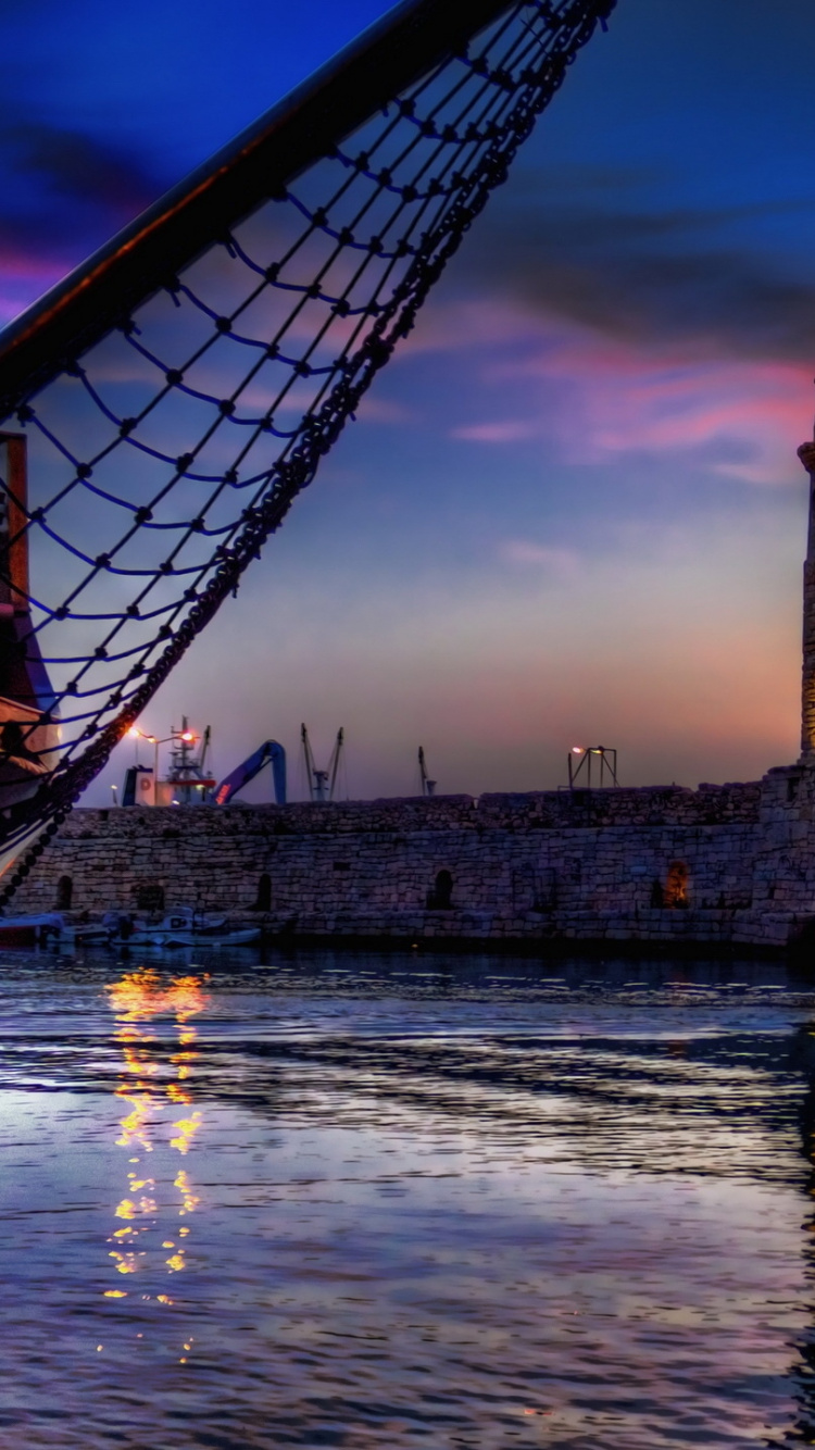 Brown and Black Tower Near Body of Water During Sunset. Wallpaper in 750x1334 Resolution