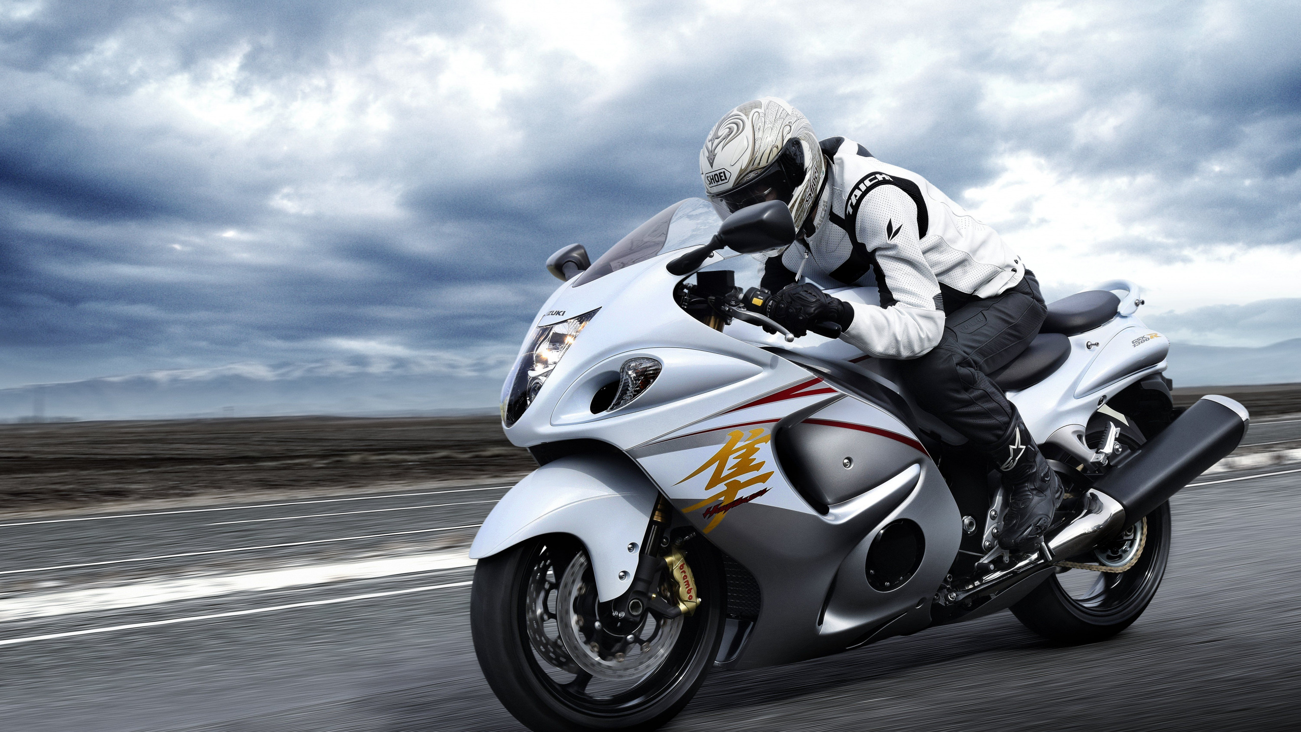 Man Riding White Sports Bike on Road During Daytime. Wallpaper in 2560x1440 Resolution