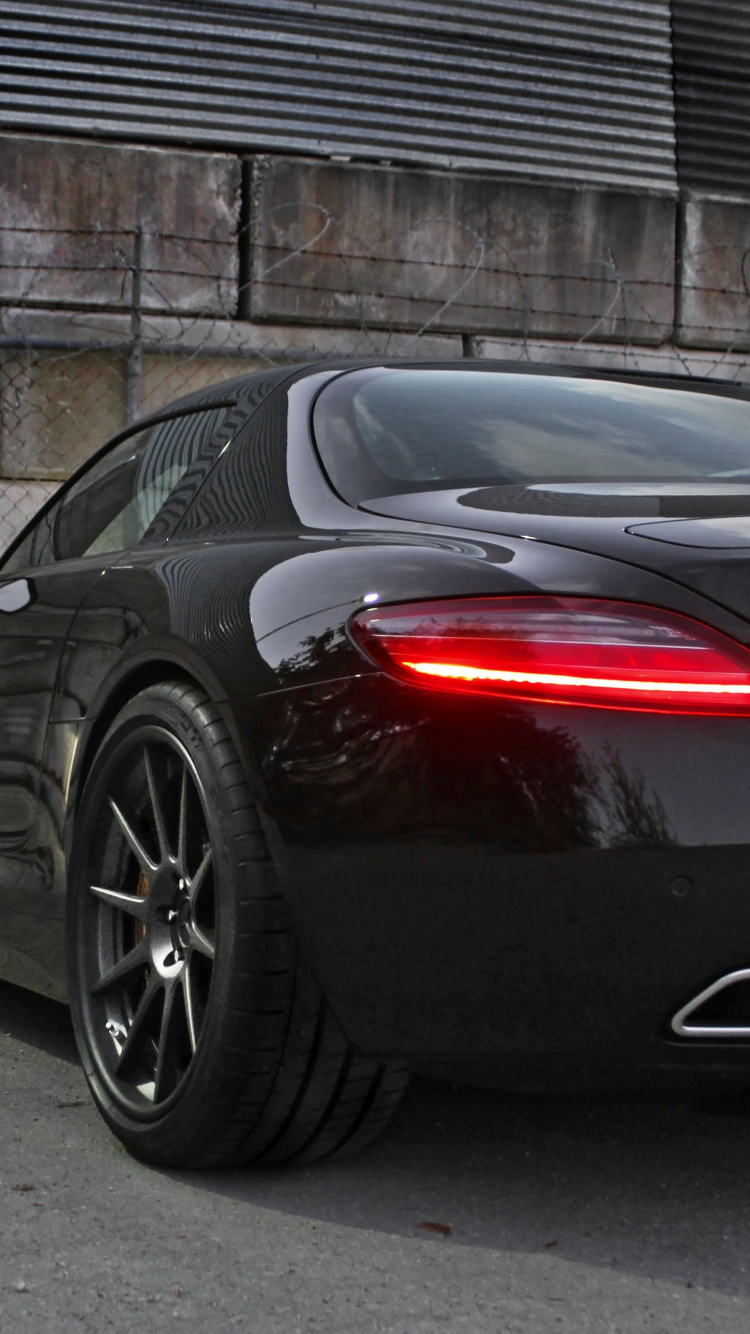Black and Red Ferrari 458 Italia Parked Beside Gray Metal Fence. Wallpaper in 750x1334 Resolution