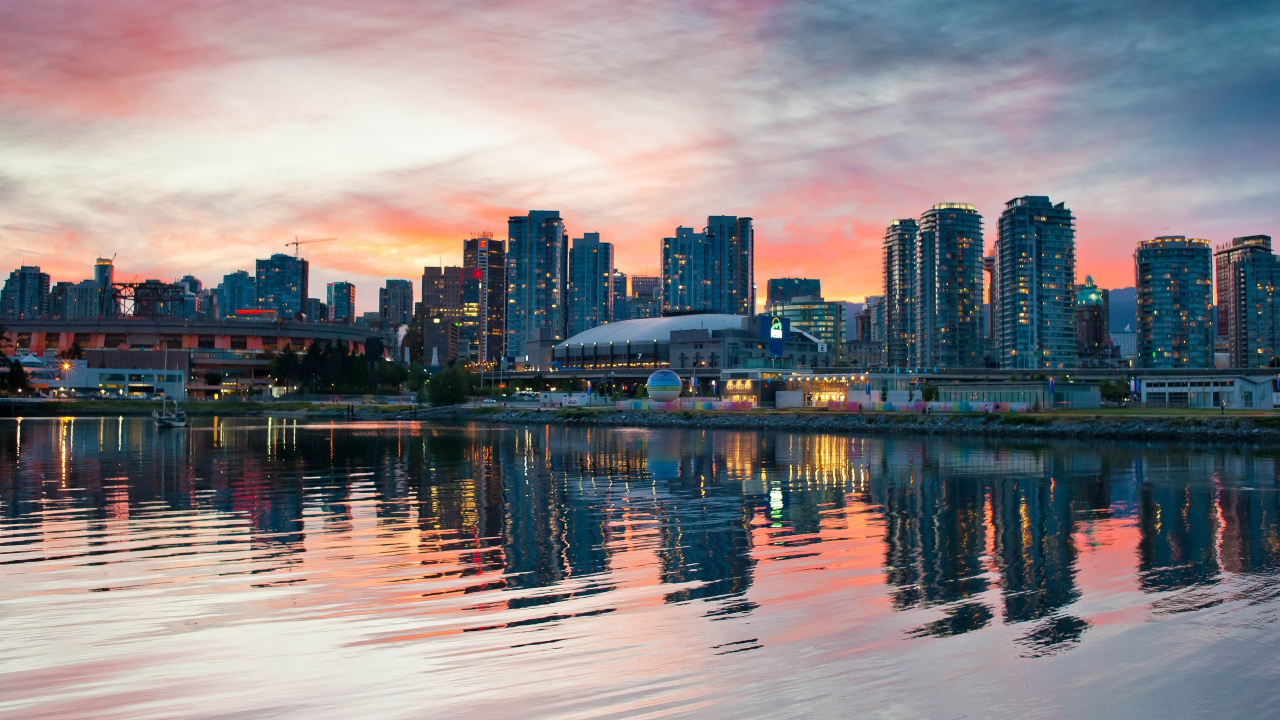 City Skyline Across Body of Water During Sunset. Wallpaper in 1280x720 Resolution