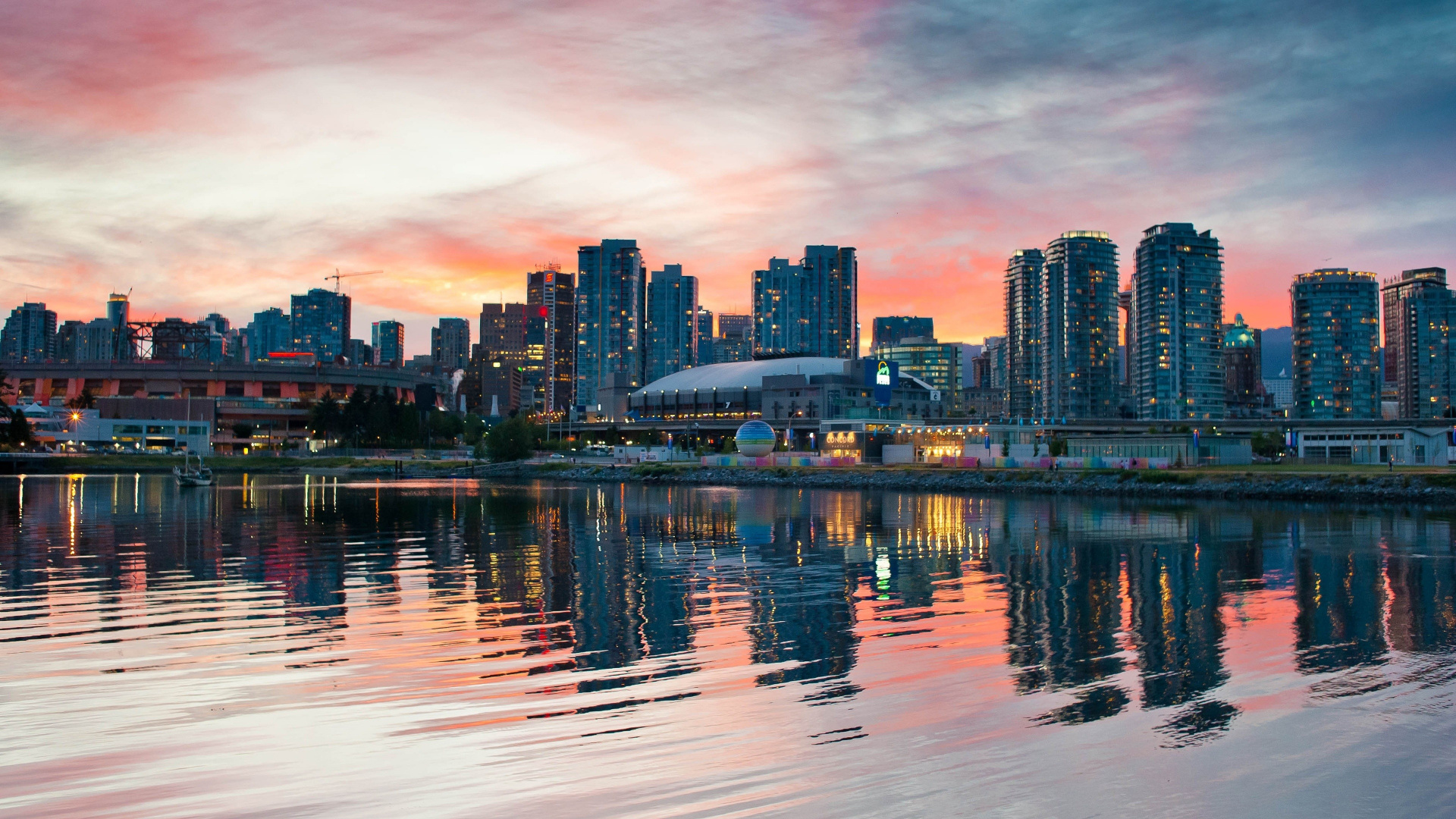 City Skyline Across Body of Water During Sunset. Wallpaper in 1920x1080 Resolution