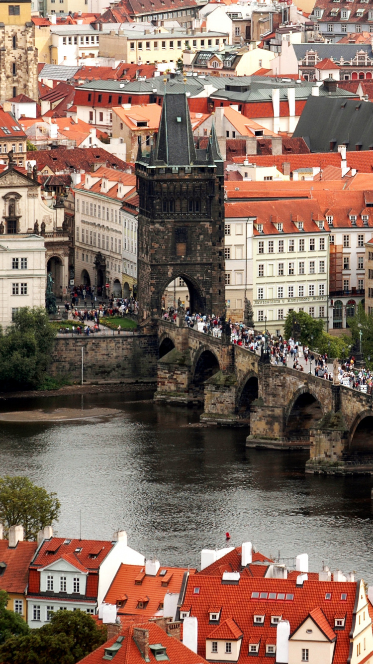 Red and White Concrete Building Near River During Daytime. Wallpaper in 750x1334 Resolution