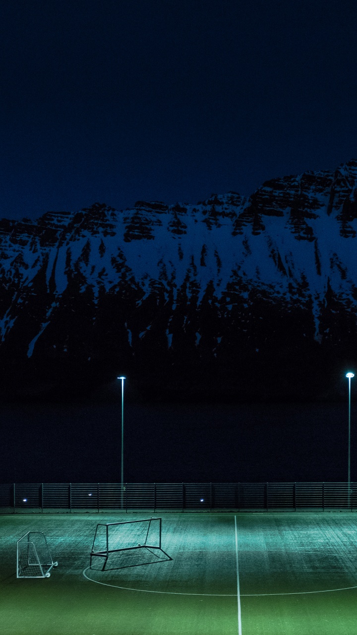 Green Grass Field Near Mountain During Night Time. Wallpaper in 720x1280 Resolution
