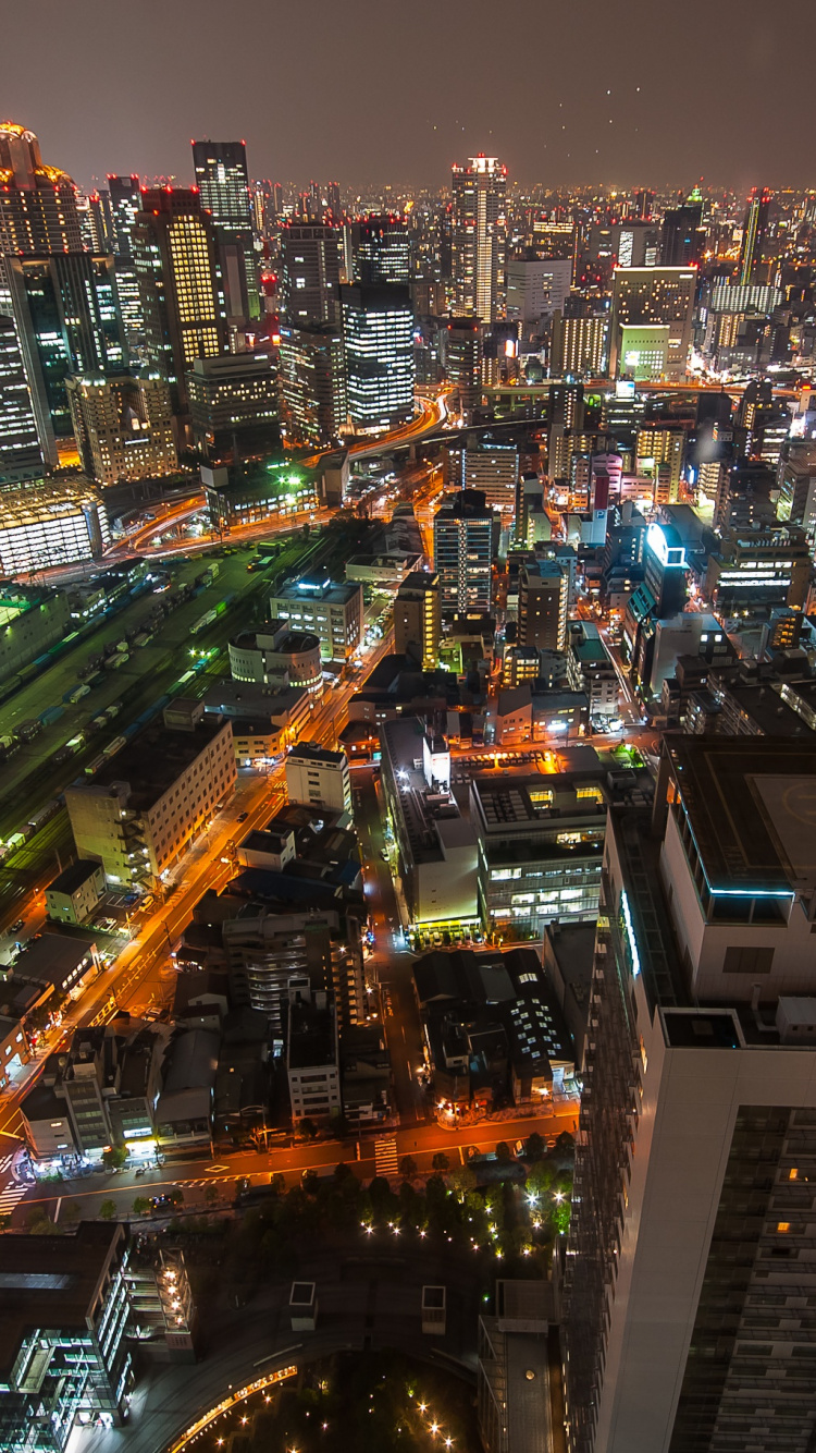 Vista Aérea de la Ciudad Durante la Noche.. Wallpaper in 750x1334 Resolution