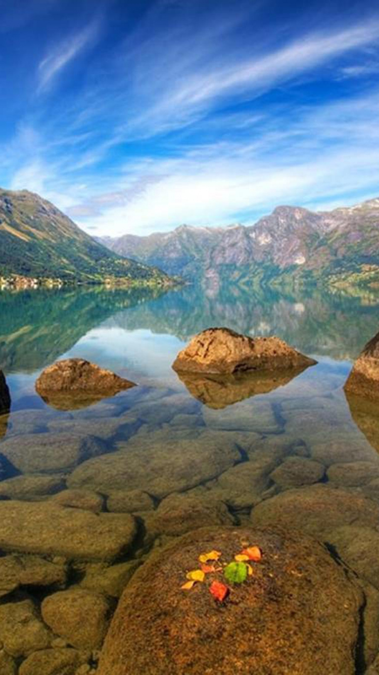 Green and Brown Mountain Beside Lake Under Blue Sky During Daytime. Wallpaper in 750x1334 Resolution