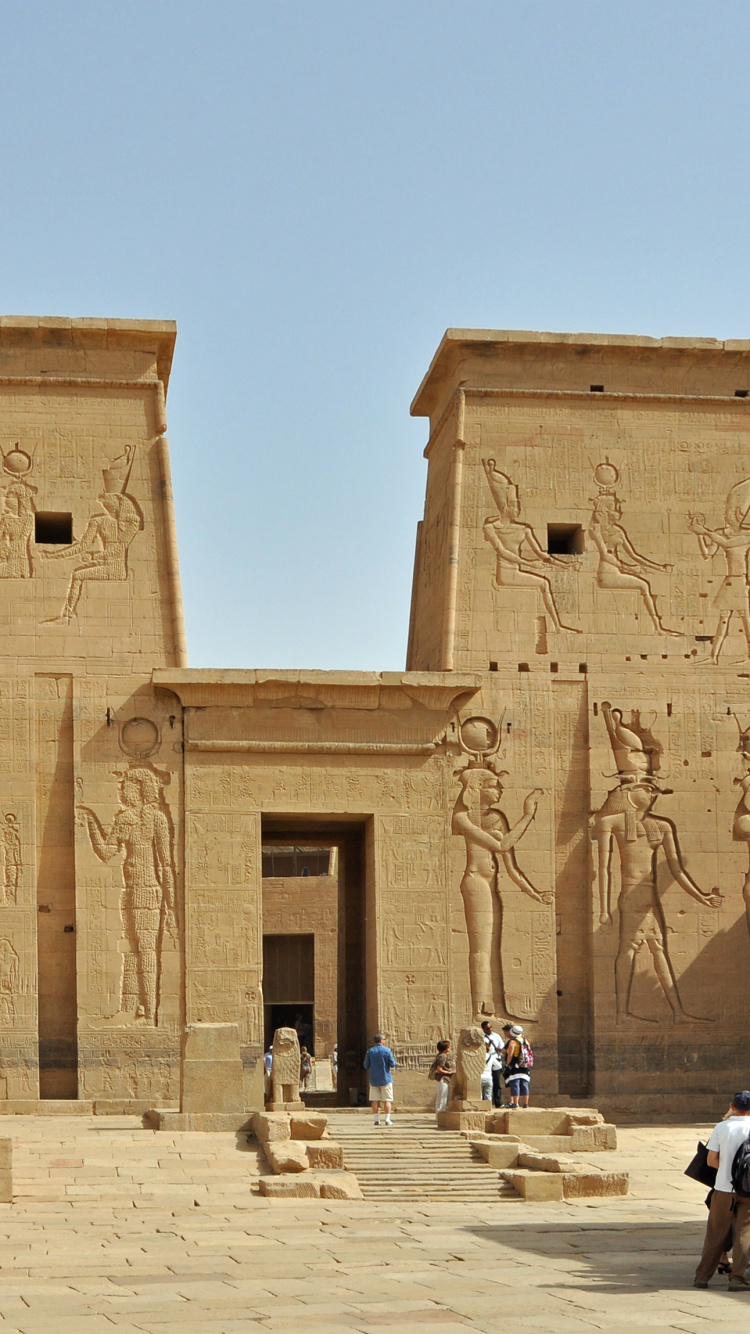 People Walking Near Brown Concrete Building During Daytime. Wallpaper in 750x1334 Resolution