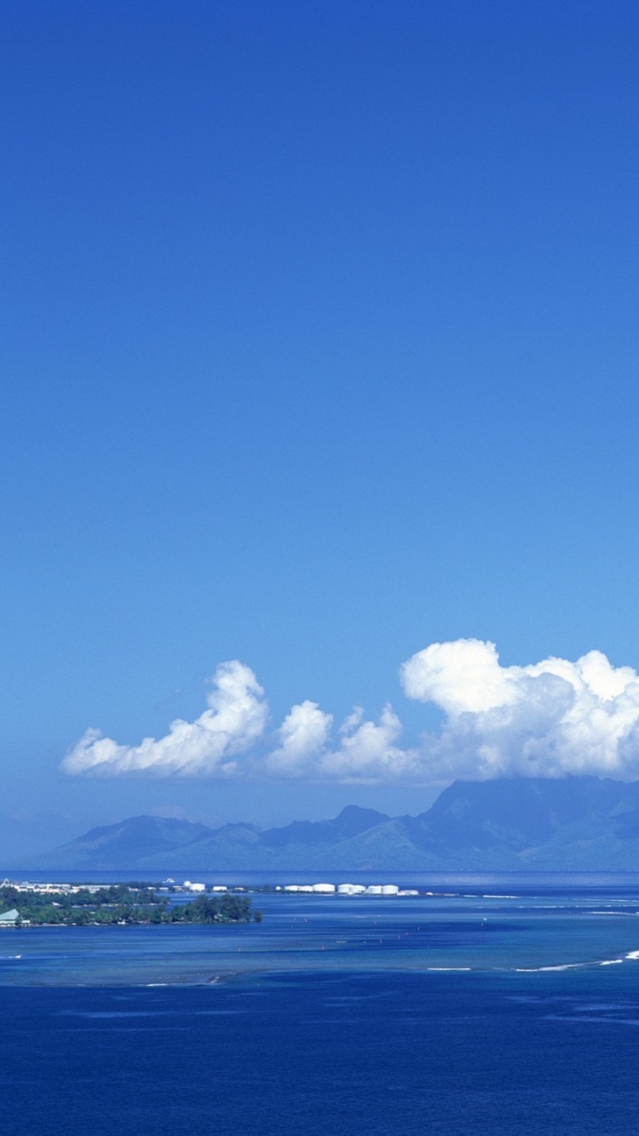 Blaues Meer Unter Blauem Himmel Tagsüber. Wallpaper in 720x1280 Resolution