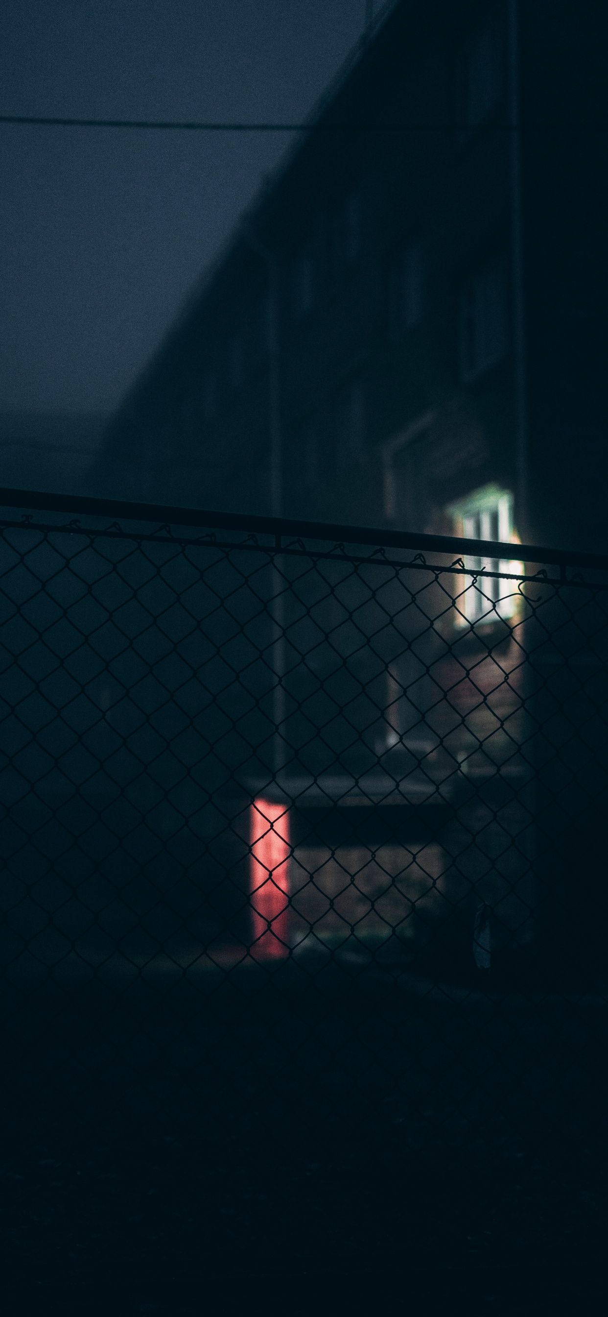 Black Metal Fence Near White Wall. Wallpaper in 1242x2688 Resolution