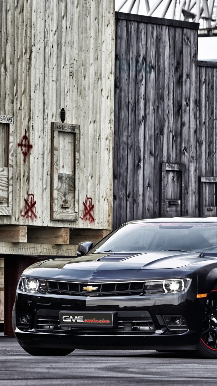Black Car Parked Beside Brown Wooden Wall. Wallpaper in 720x1280 Resolution