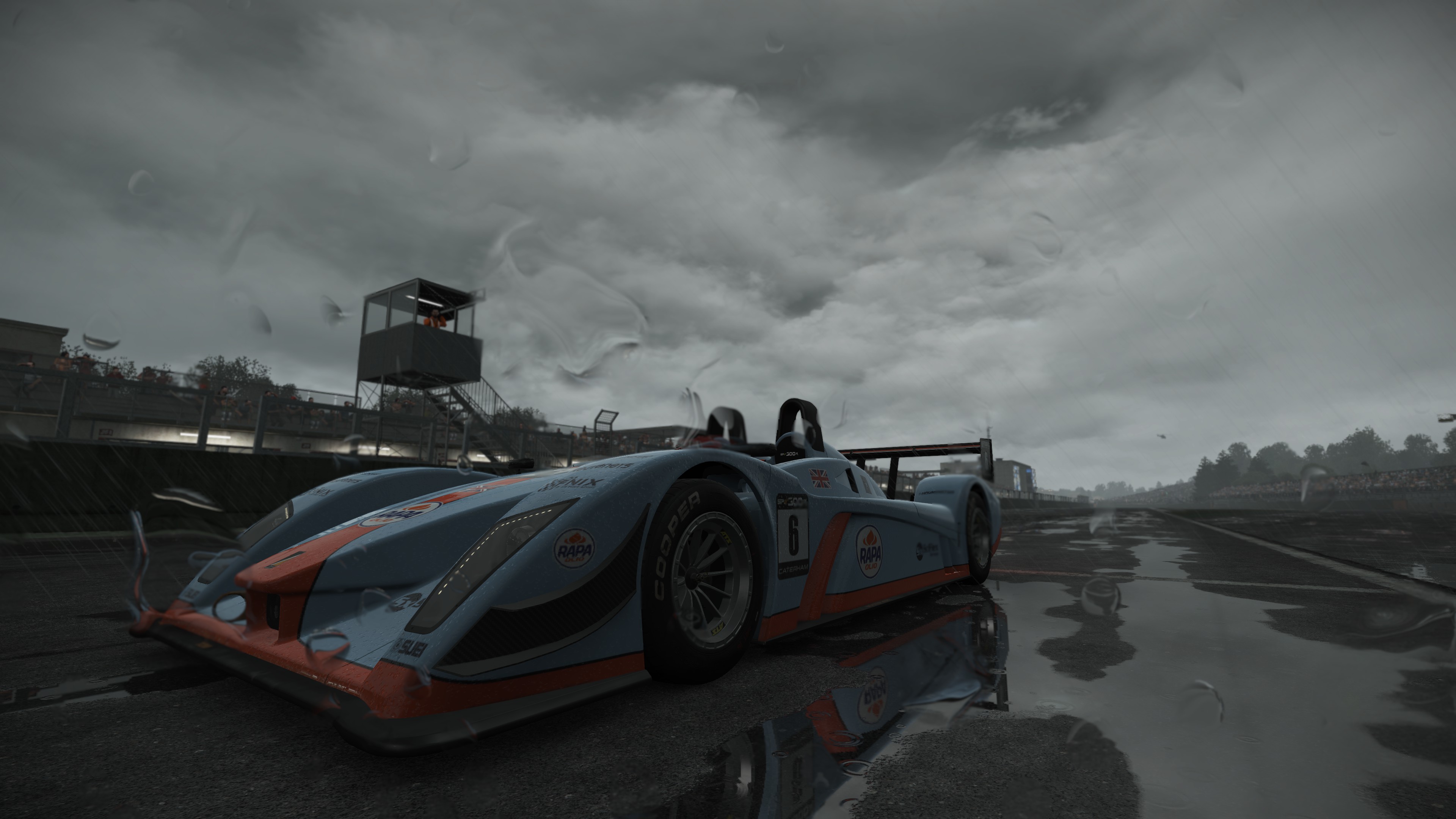 Schwarzer Und Roter Ferrari f 1 Auf Grauem Sand Unter Grauem Bewölktem Himmel Tagsüber. Wallpaper in 3840x2160 Resolution