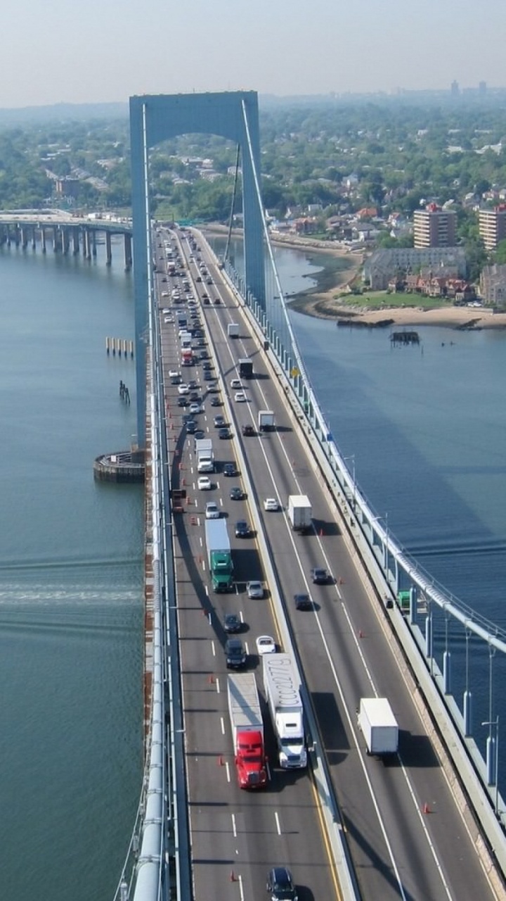 Gray Concrete Bridge Over Body of Water During Daytime. Wallpaper in 720x1280 Resolution