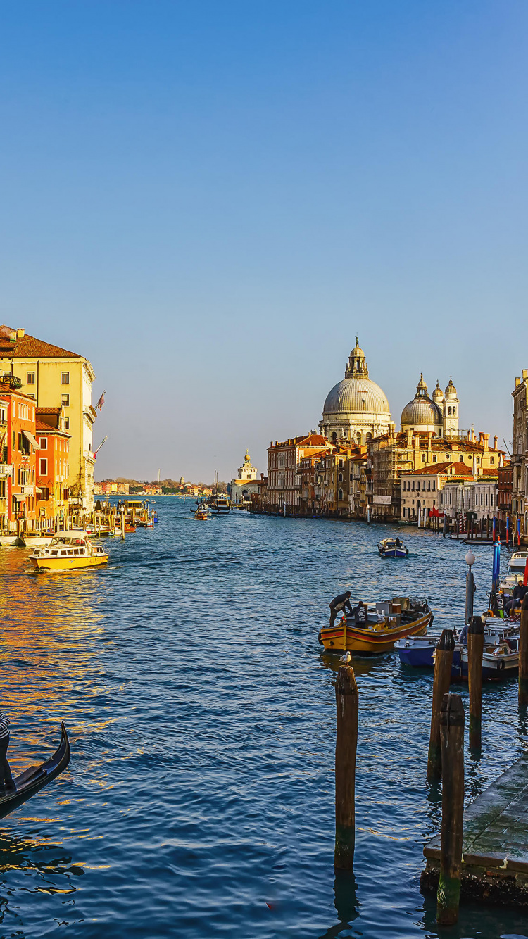 People Riding on Boat on River Near Buildings During Daytime. Wallpaper in 750x1334 Resolution