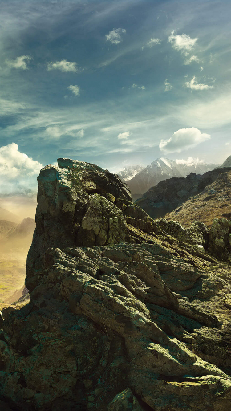 Brown Rocky Mountain Under Blue Sky During Daytime. Wallpaper in 750x1334 Resolution