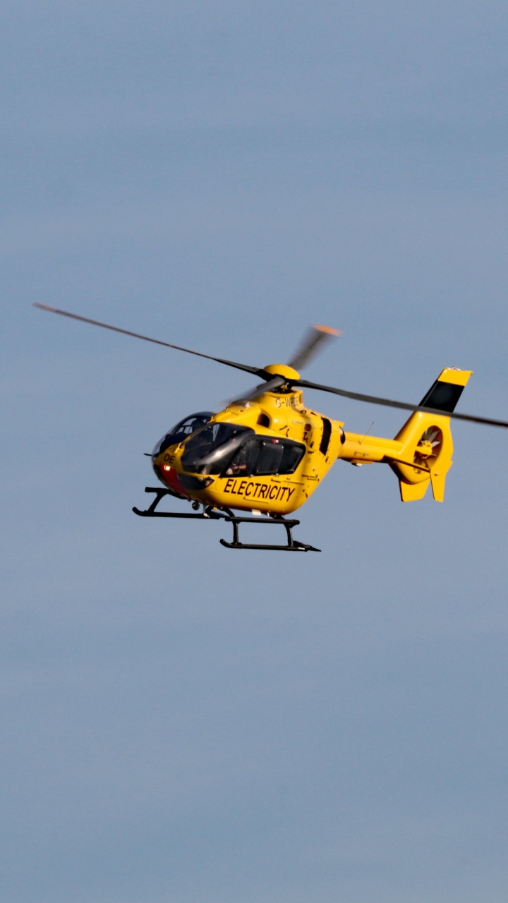 Yellow and Black Helicopter Flying in The Sky. Wallpaper in 720x1280 Resolution