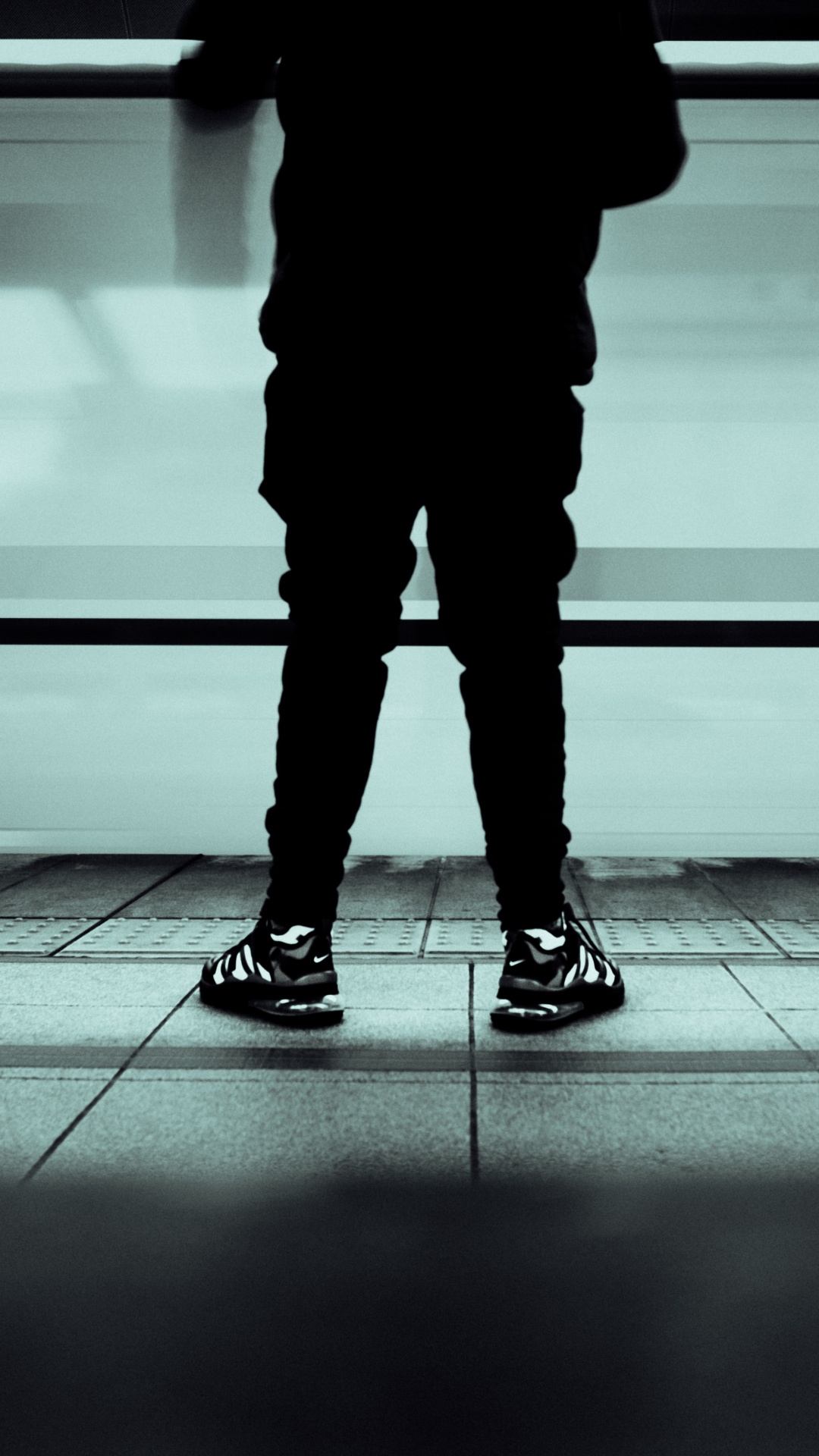 Person in Black Pants and Black Shoes Standing on Gray Floor. Wallpaper in 1080x1920 Resolution