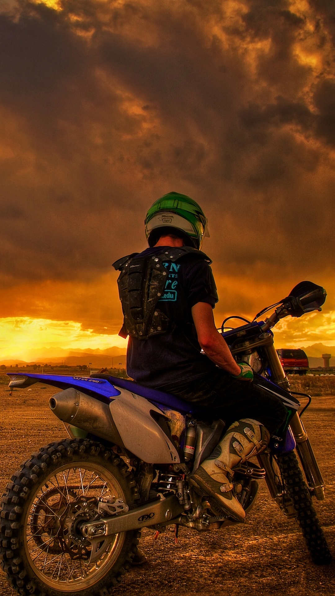 Mann, Der Während Des Sonnenuntergangs Motorrad Auf Braunem Feld Reitet. Wallpaper in 1080x1920 Resolution