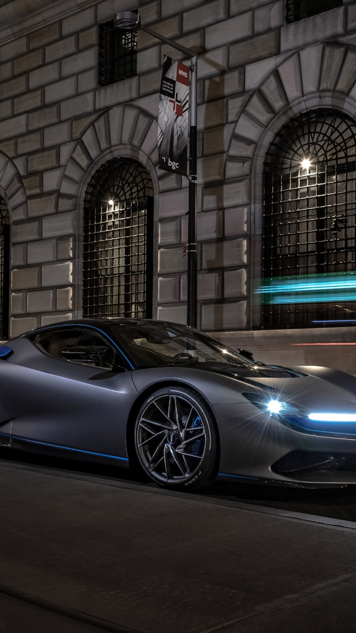 Black Coupe Parked Beside Building. Wallpaper in 720x1280 Resolution