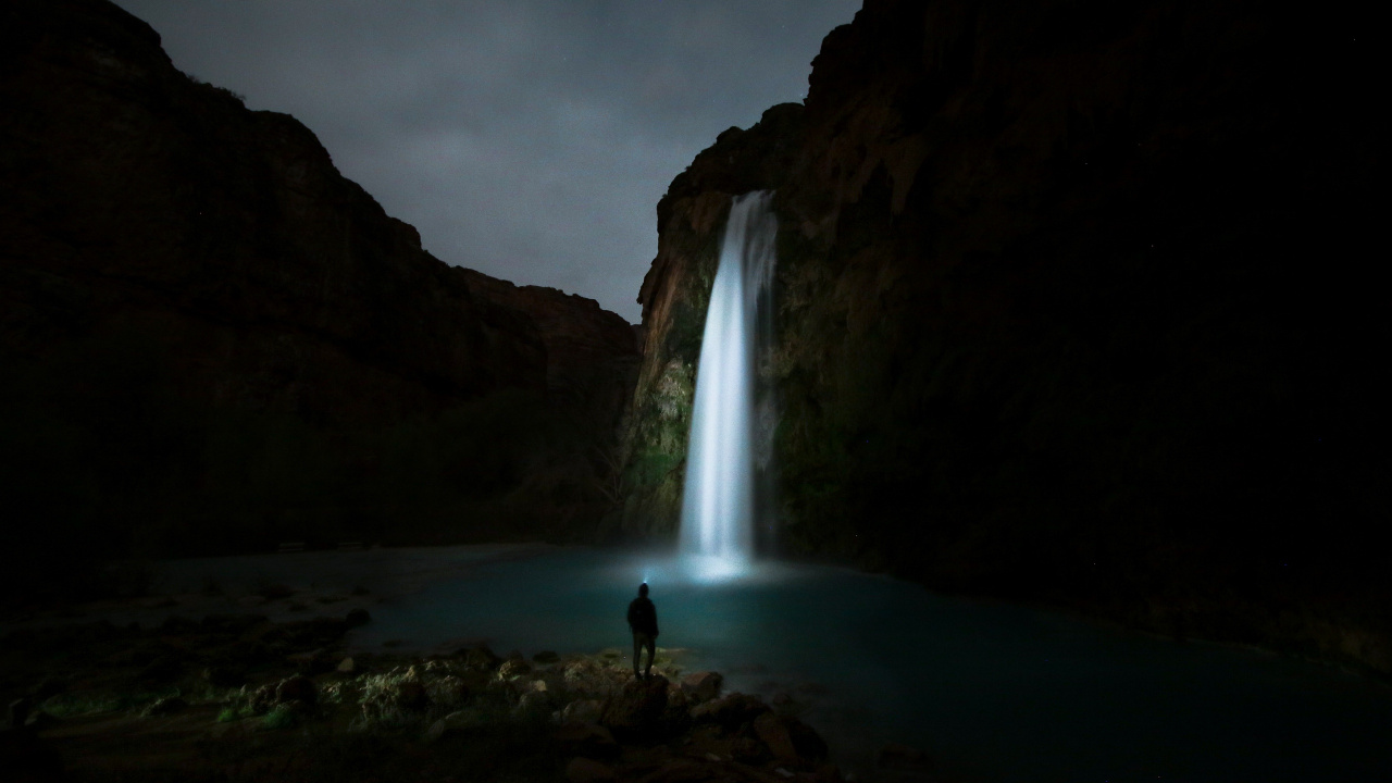 Man Standing on Rock Near Waterfalls During Daytime. Wallpaper in 1280x720 Resolution