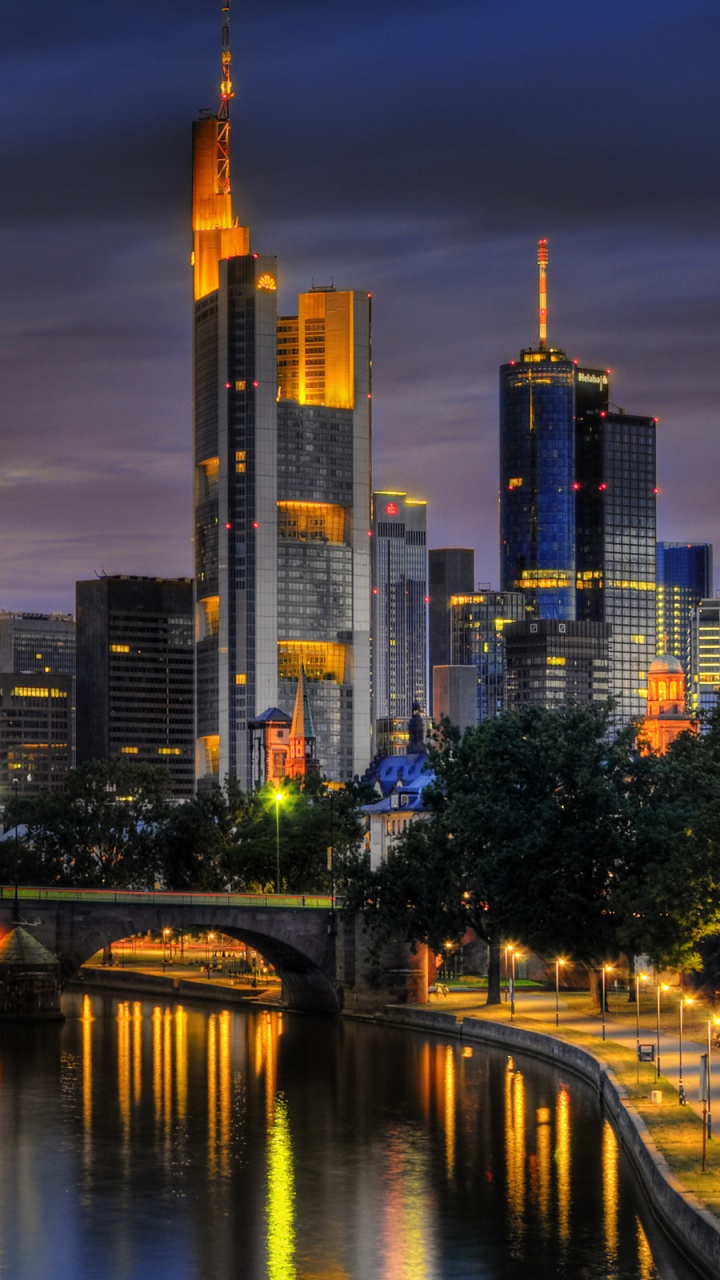 City Skyline Across Body of Water During Night Time. Wallpaper in 720x1280 Resolution