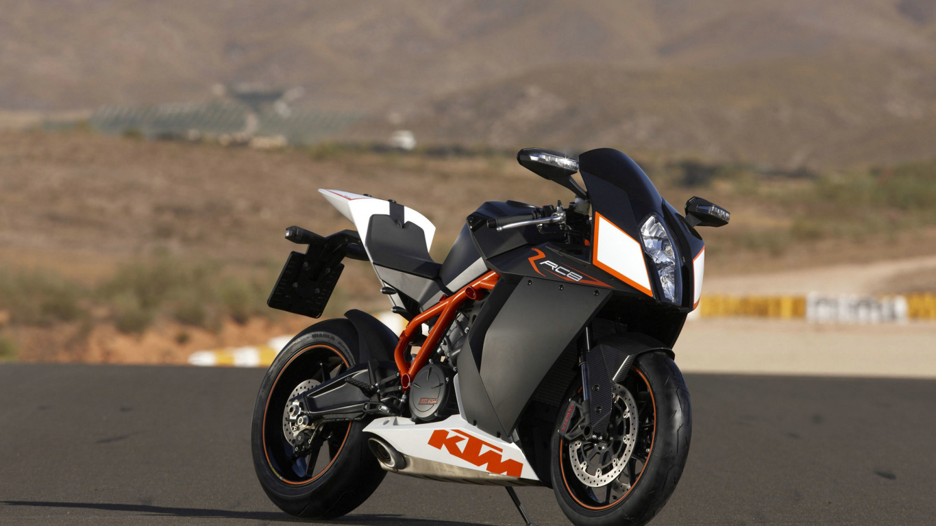 Vélo de Sport Noir et Orange Sur Route Pendant la Journée. Wallpaper in 1366x768 Resolution