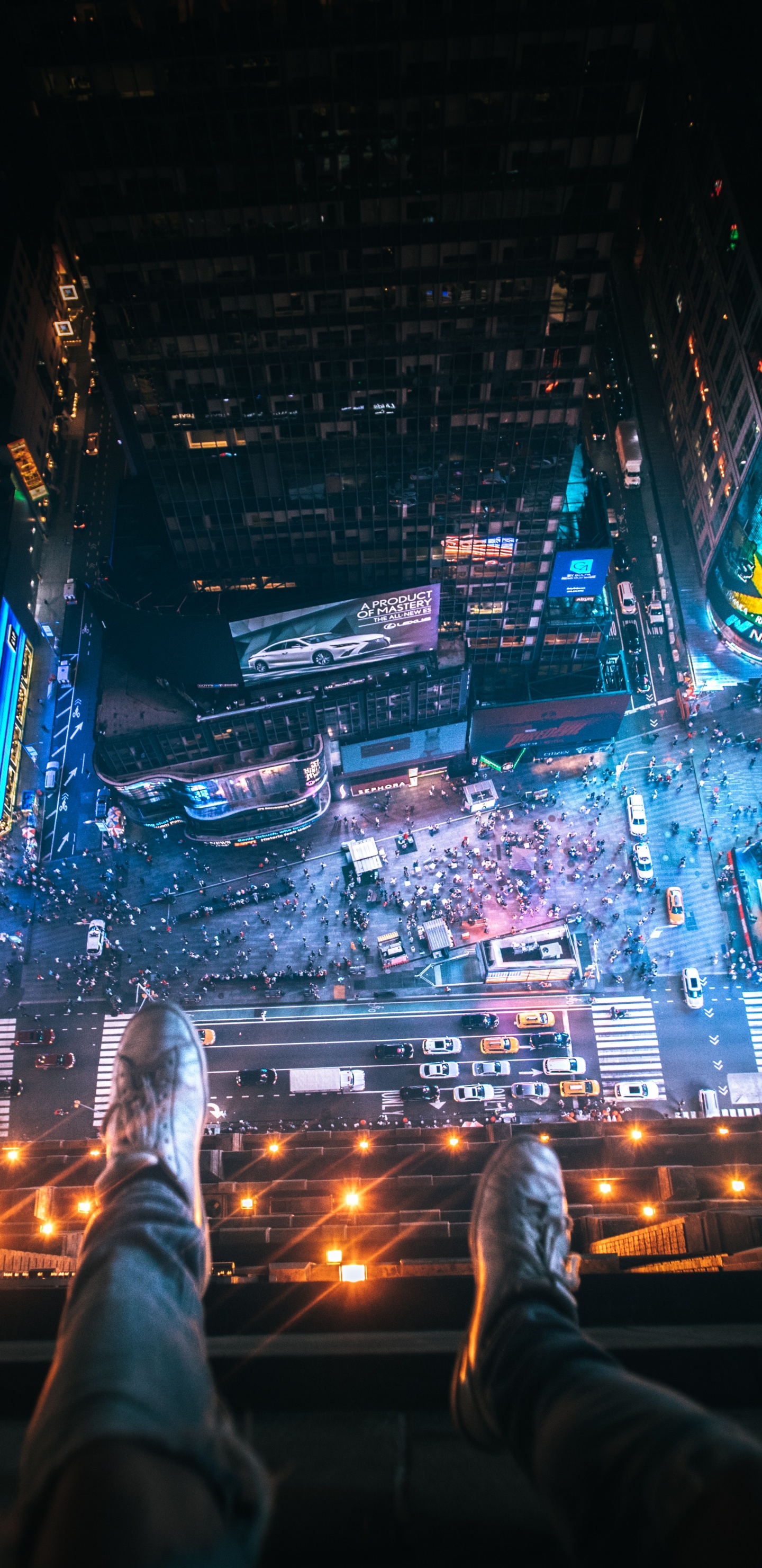 Person in Black Pants and Black Shoes on Top of The Building During Night Time. Wallpaper in 1440x2960 Resolution