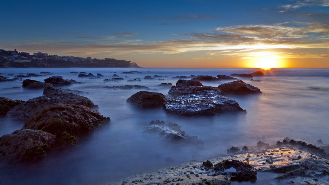Rocky Shore Under Blue Sky During Daytime. Wallpaper in 1366x768 Resolution