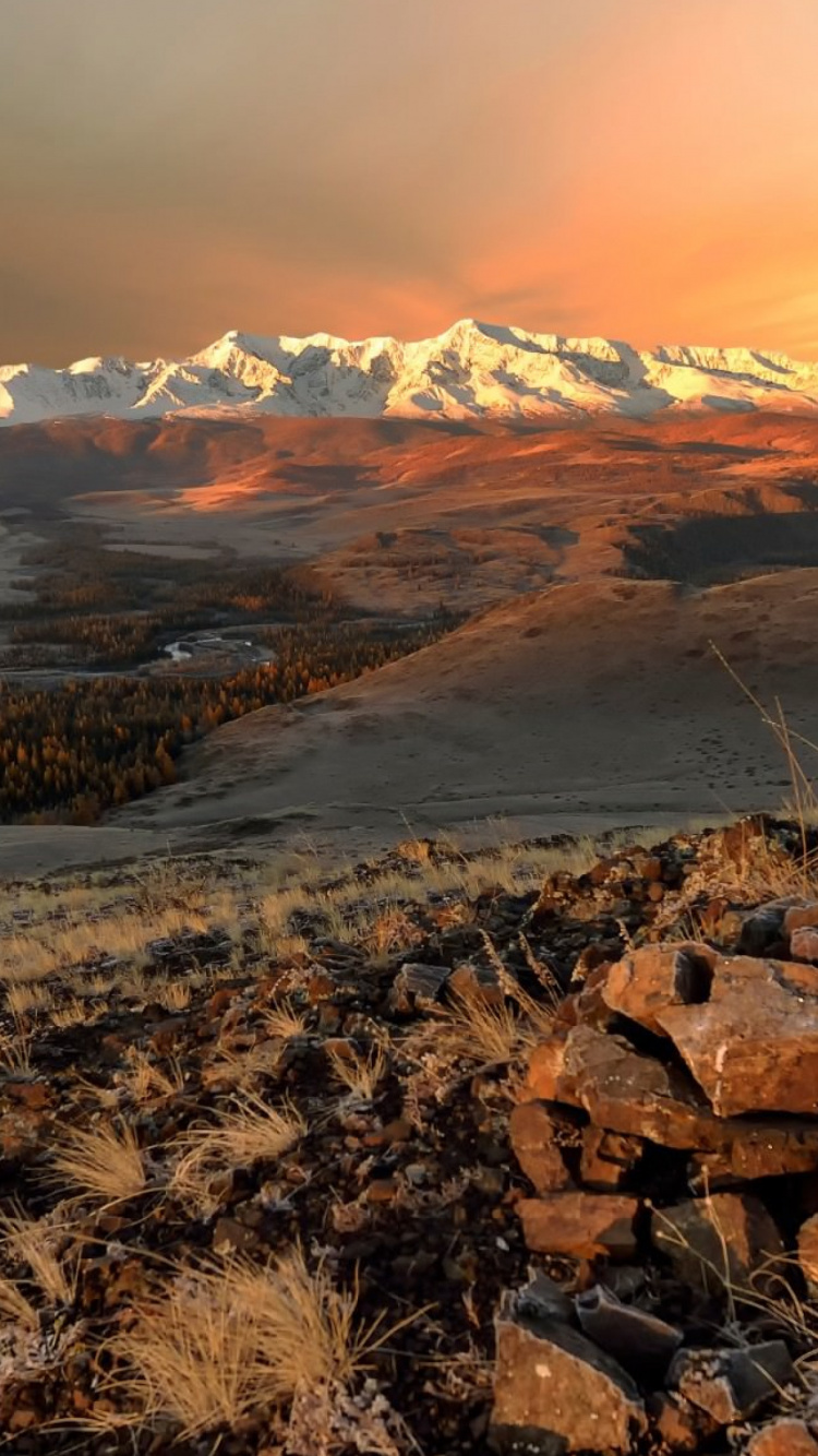 Brown and Gray Rocky Mountain Under White Cloudy Sky During Daytime. Wallpaper in 750x1334 Resolution