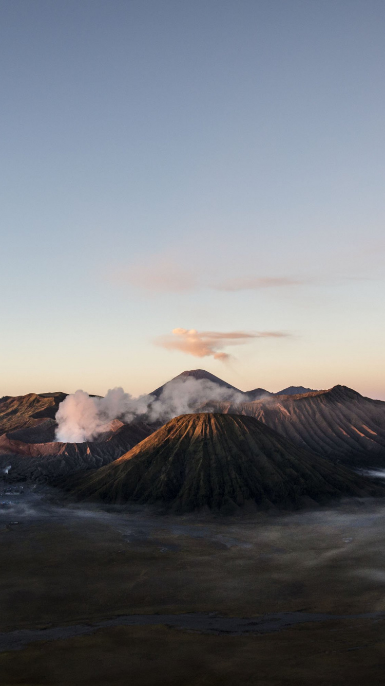 Brown Mountain Under Blue Sky During Daytime. Wallpaper in 750x1334 Resolution