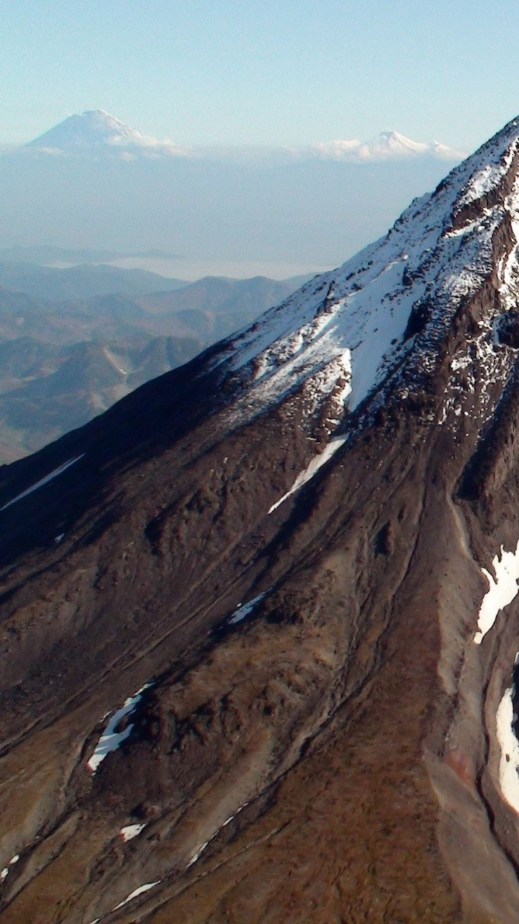 Brown and White Mountain Under Blue Sky During Daytime. Wallpaper in 750x1334 Resolution