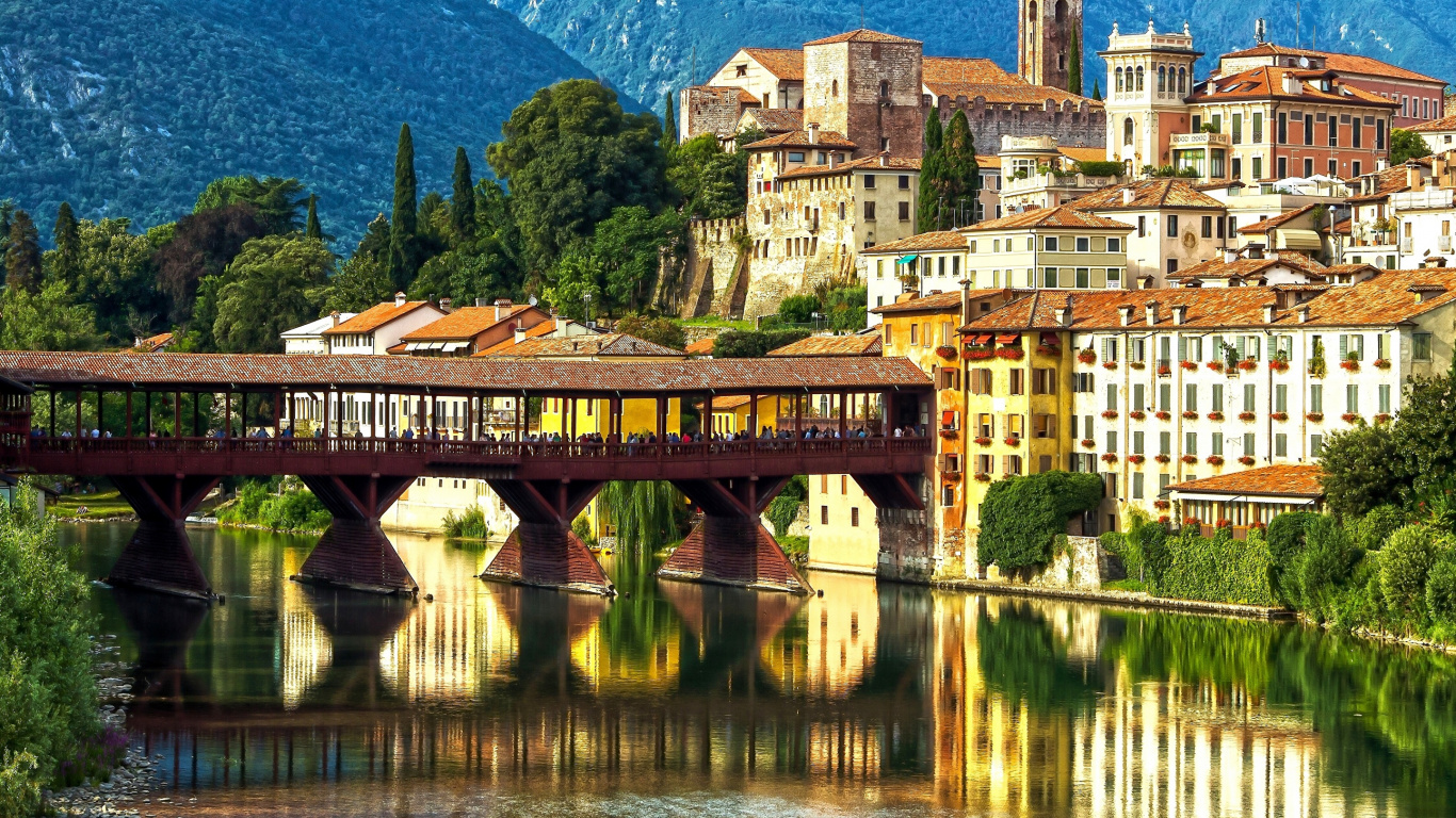 Brown Concrete Building Near Body of Water During Daytime. Wallpaper in 1366x768 Resolution