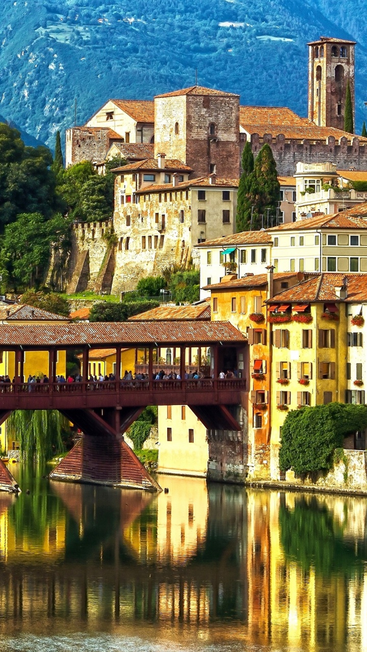 Brown Concrete Building Near Body of Water During Daytime. Wallpaper in 720x1280 Resolution