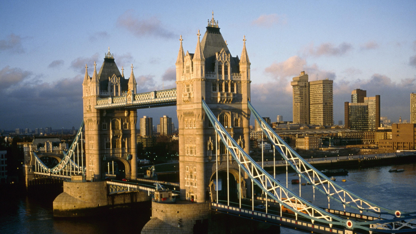 Brown Concrete Building Near Bridge Under Blue Sky During Daytime. Wallpaper in 1366x768 Resolution