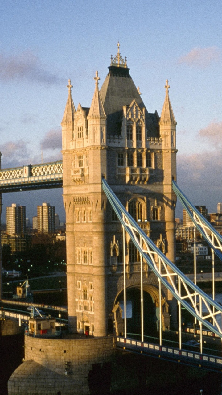 Brown Concrete Building Near Bridge Under Blue Sky During Daytime. Wallpaper in 720x1280 Resolution