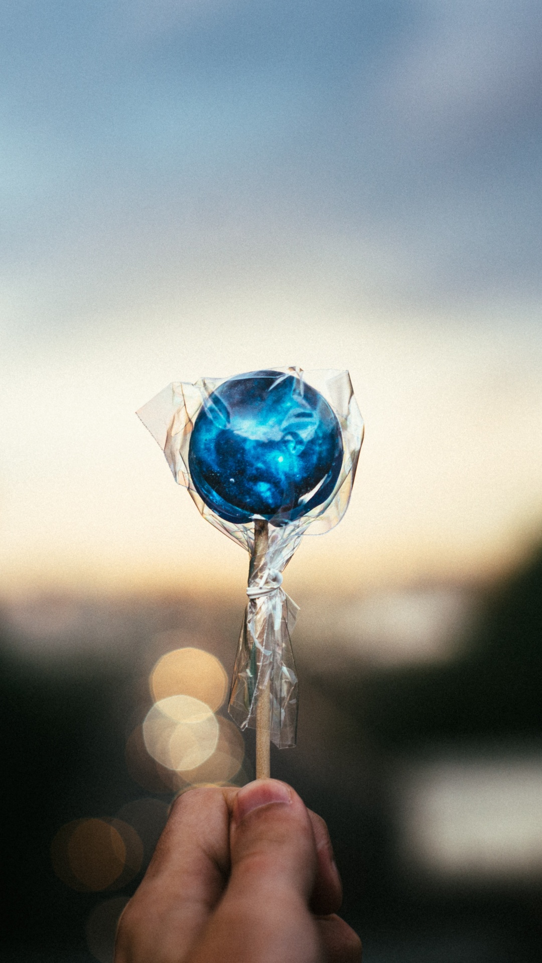 Person Holding Blue Heart Lollipop. Wallpaper in 1080x1920 Resolution