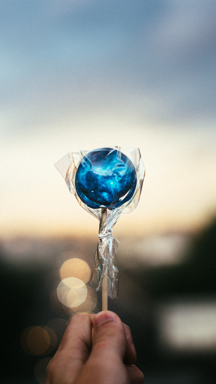 Person Holding Blue Heart Lollipop. Wallpaper in 750x1334 Resolution