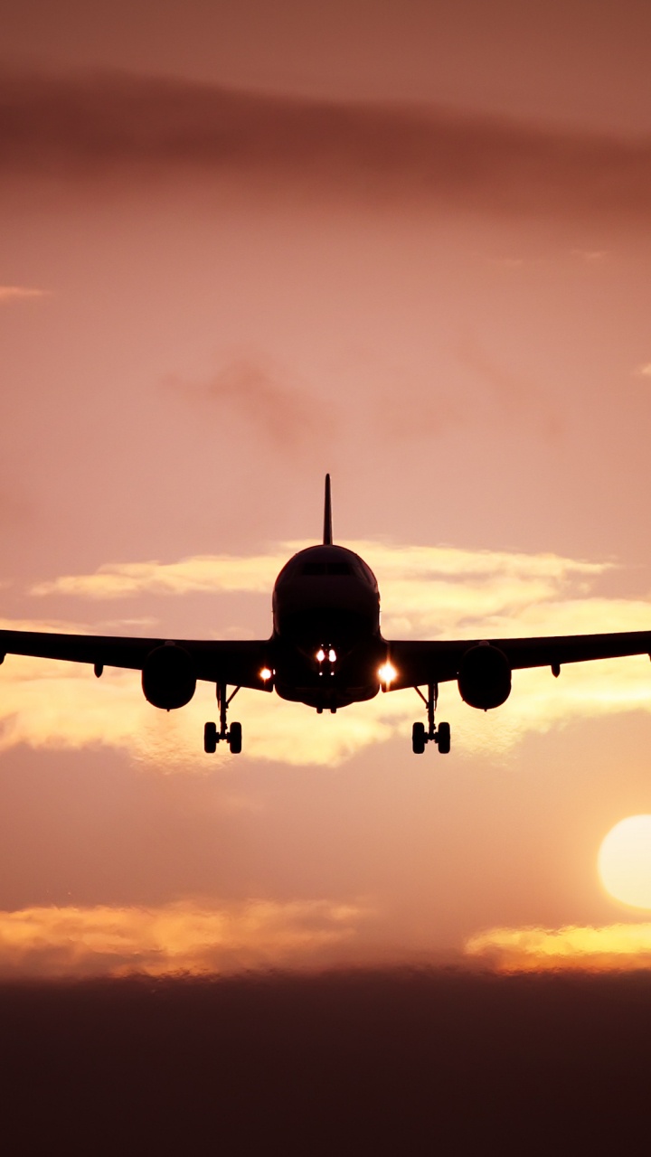 Airplane Flying in The Sky During Sunset. Wallpaper in 720x1280 Resolution