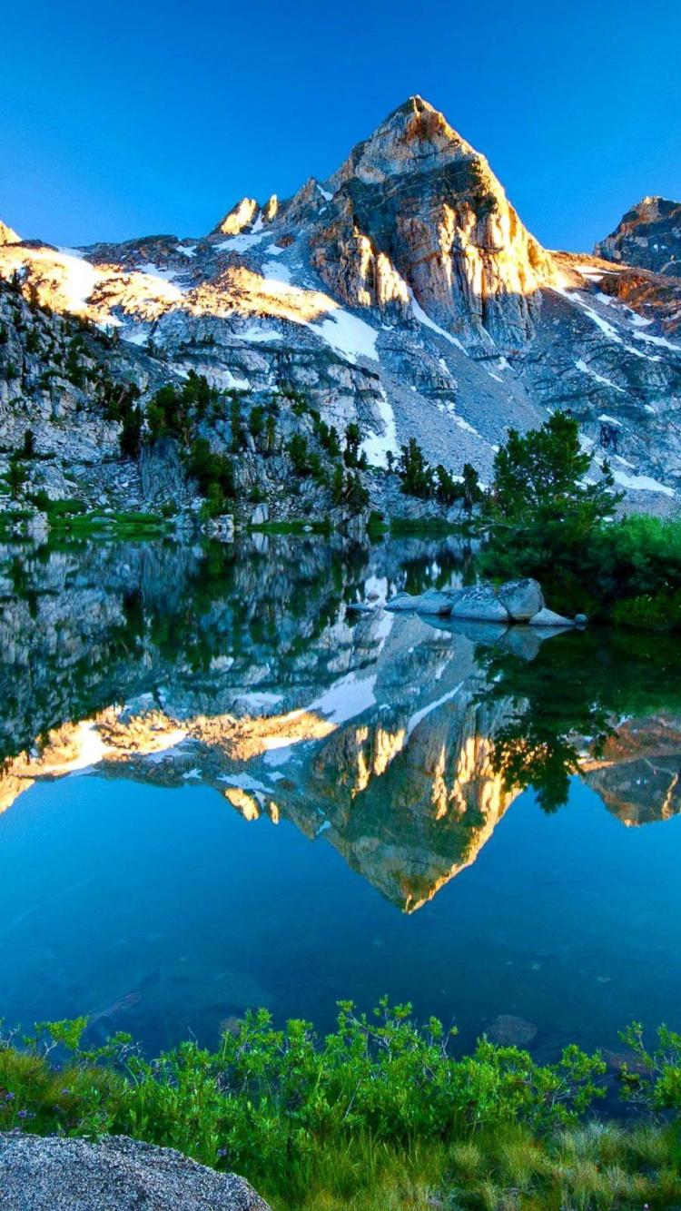 Snow Covered Mountain Near Lake During Daytime. Wallpaper in 750x1334 Resolution
