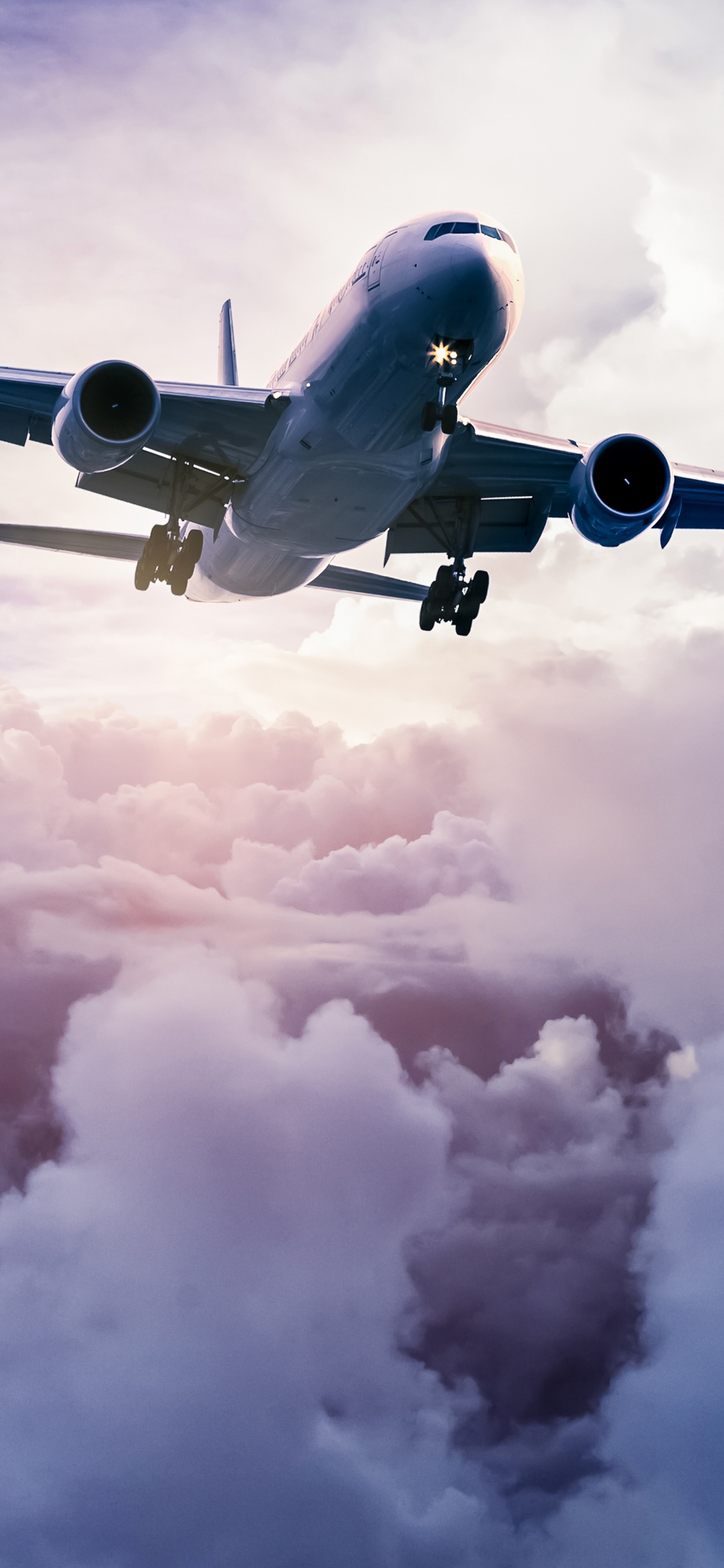 Avion Blanc et Bleu Volant Dans le Ciel. Wallpaper in 1125x2436 Resolution