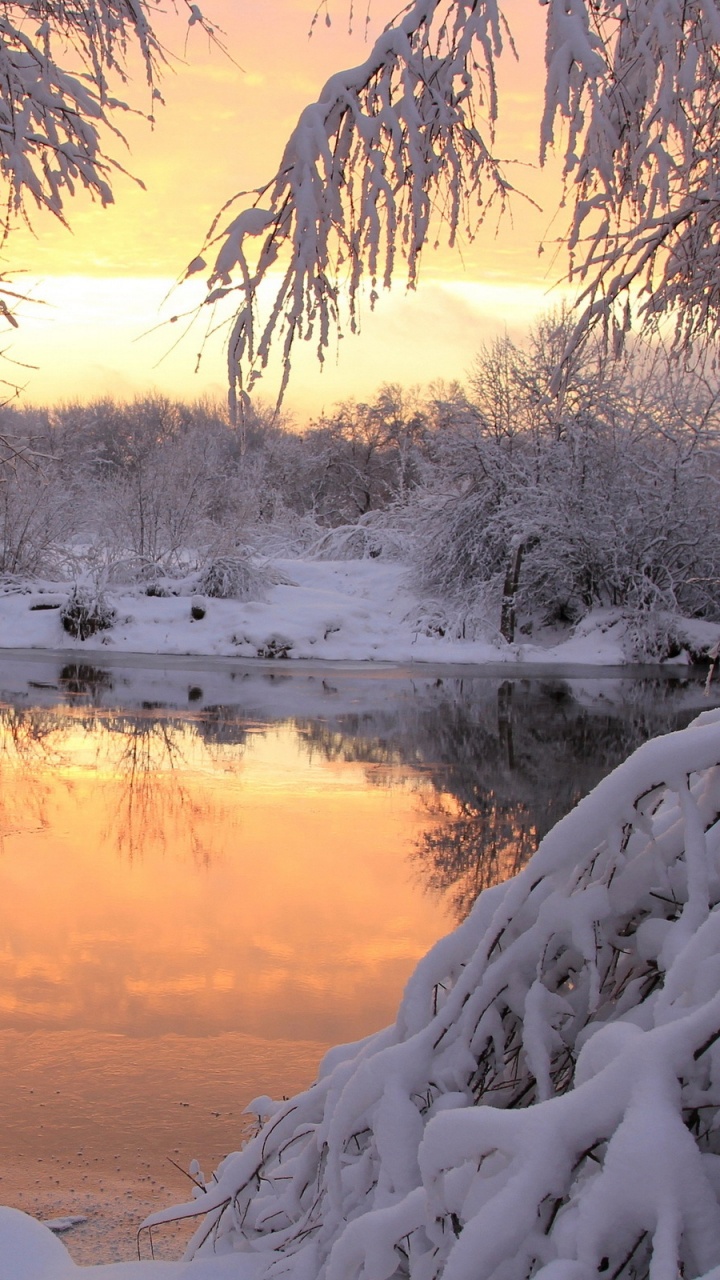 Snow Covered Ground Near Body of Water During Daytime. Wallpaper in 720x1280 Resolution