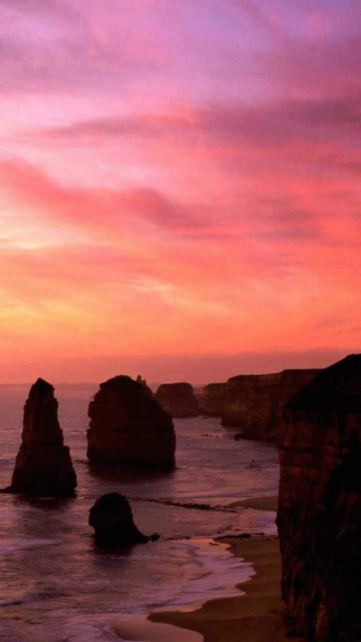 Silhouette of Rocks on Sea Shore During Sunset. Wallpaper in 720x1280 Resolution