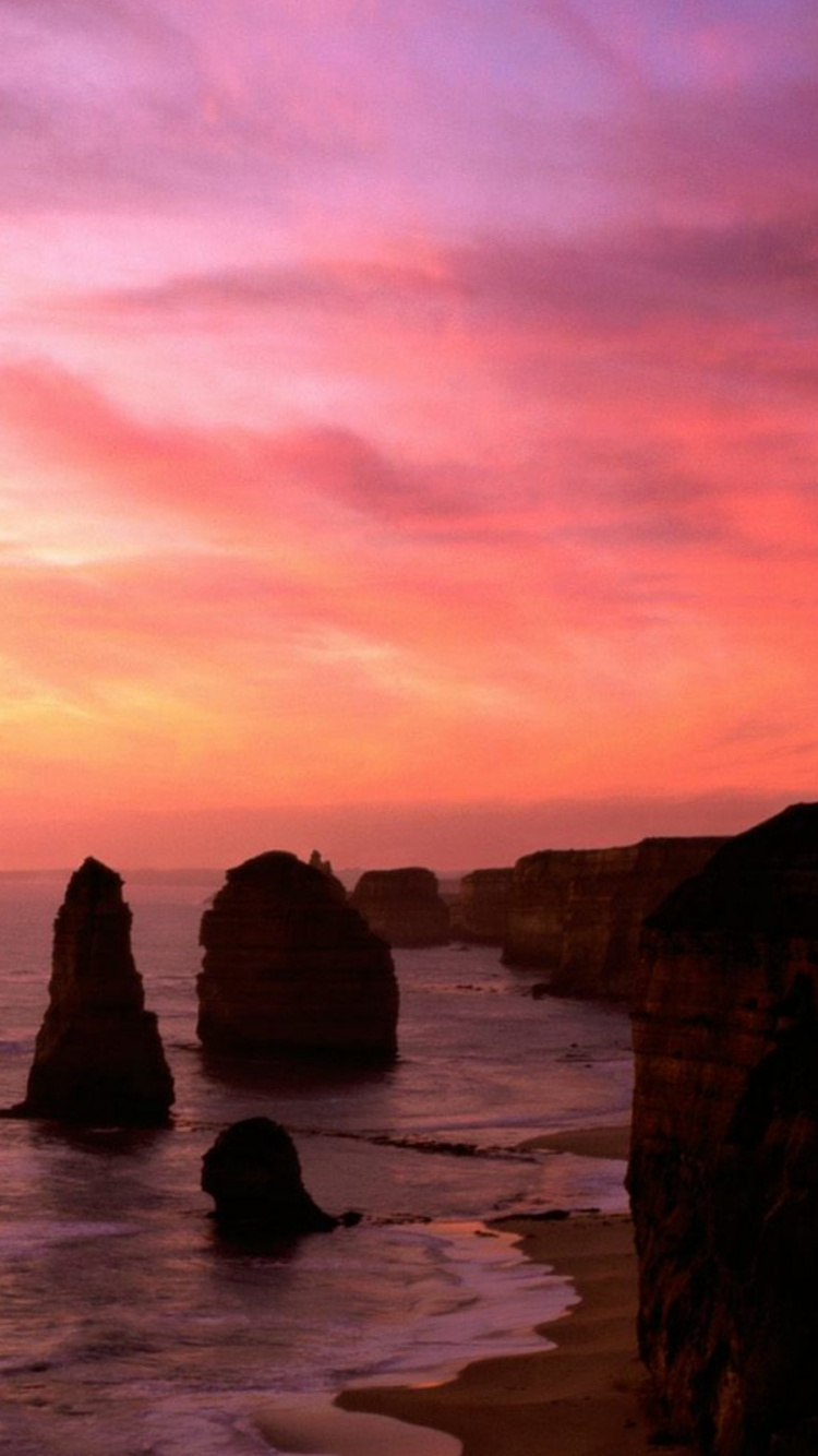 Silhouette of Rocks on Sea Shore During Sunset. Wallpaper in 750x1334 Resolution