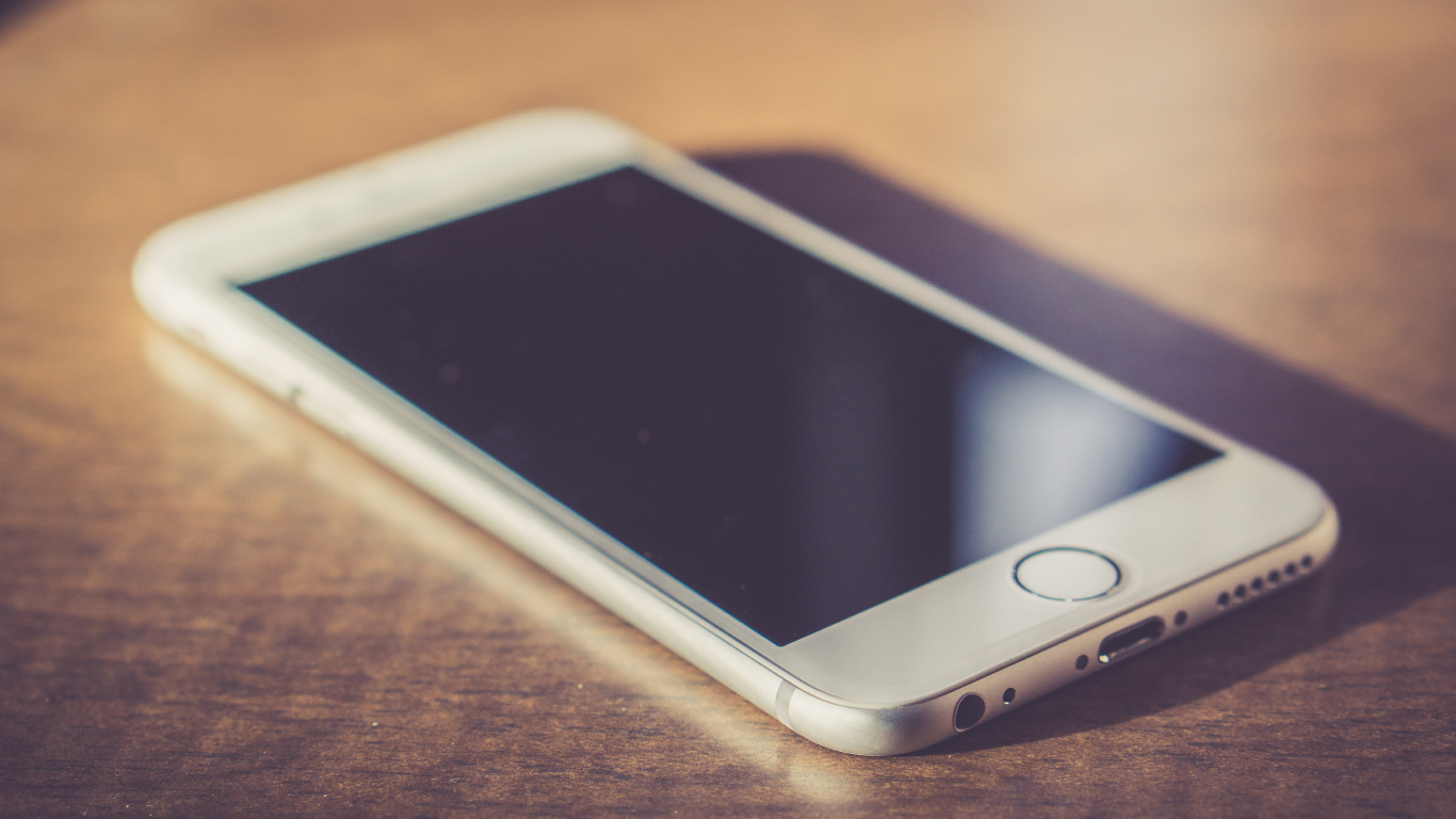 Gold Iphone 6 on Brown Wooden Table. Wallpaper in 1366x768 Resolution