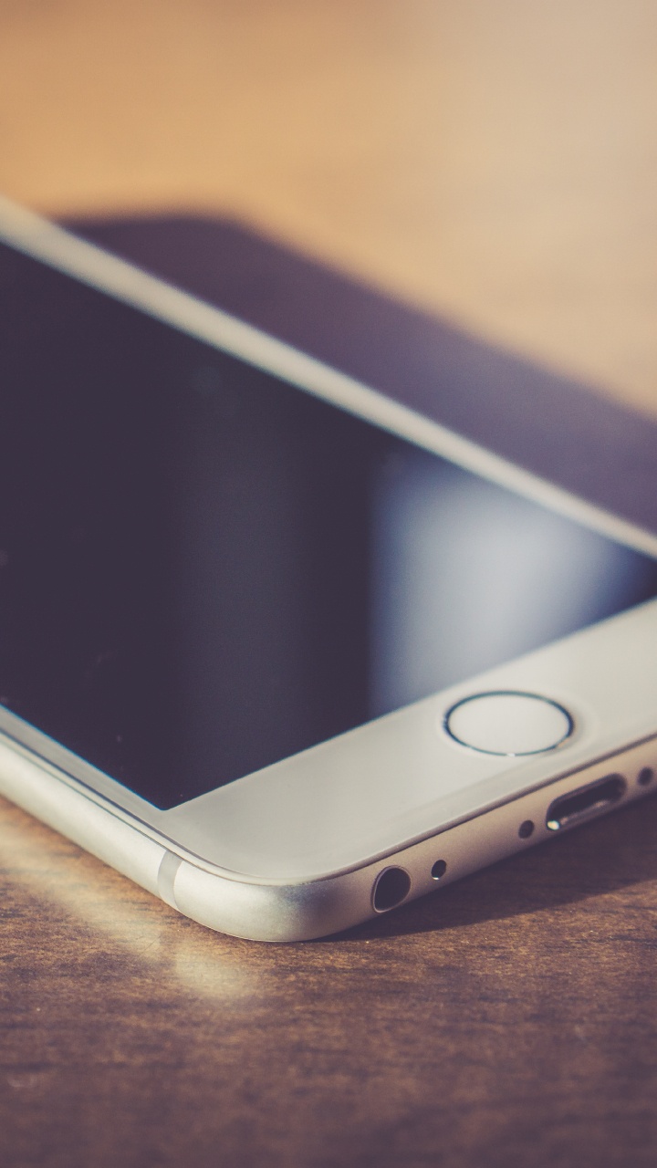 Gold Iphone 6 on Brown Wooden Table. Wallpaper in 720x1280 Resolution