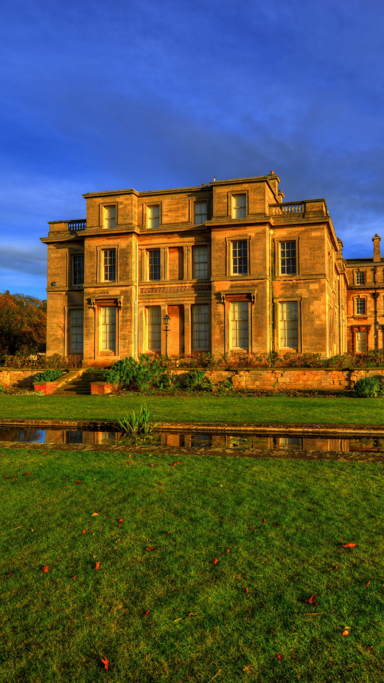 Brown Concrete Building Near Green Grass Field Under Blue Sky During Daytime. Wallpaper in 750x1334 Resolution