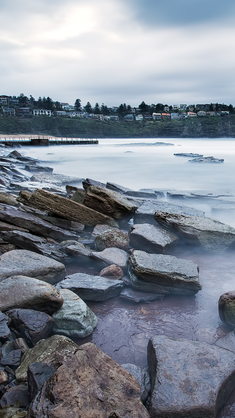 Brown and Green Rock Formation on Sea Shore During Daytime. Wallpaper in 750x1334 Resolution