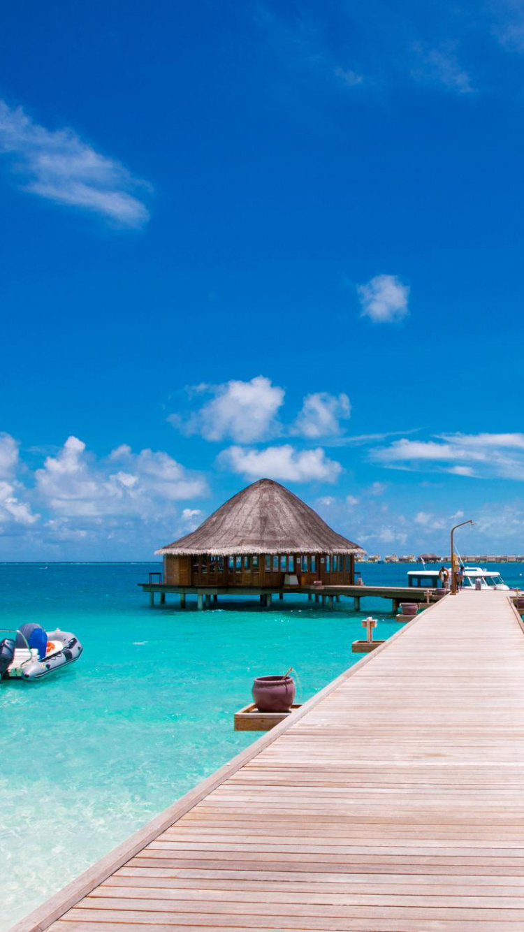 Brown Wooden Dock on Blue Sea Under Blue Sky During Daytime. Wallpaper in 750x1334 Resolution